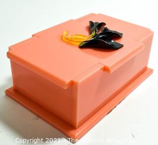 Mid Century Art Deco Salmon Pink Bakelite Trinket Box with Applied Decoration. Measures 7"L.