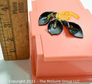 Mid Century Art Deco Salmon Pink Bakelite Trinket Box with Applied Decoration. Measures 7"L.