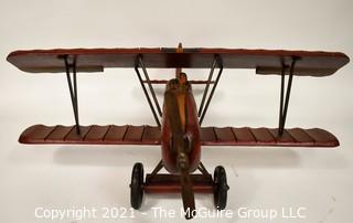 Vintage Red Painted Folk Art Hanging Wooden Biplane with Pilot.  Measures 26"L x  14"T  x 27"W. (TMG Business card placed for size perspective)