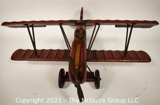 Vintage Red Painted Folk Art Hanging Wooden Biplane with Pilot.  Measures 26"L x  14"T  x 27"W. (TMG Business card placed for size perspective)