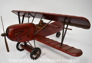 Vintage Red Painted Folk Art Hanging Wooden Biplane with Pilot.  Measures 26"L x  14"T  x 27"W. (TMG Business card placed for size perspective)