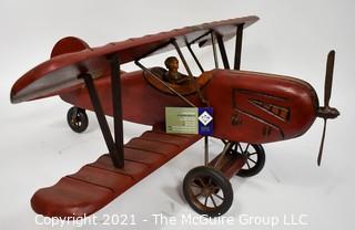 Vintage Red Painted Folk Art Hanging Wooden Biplane with Pilot.  Measures 26"L x  14"T  x 27"W. (TMG Business card placed for size perspective)