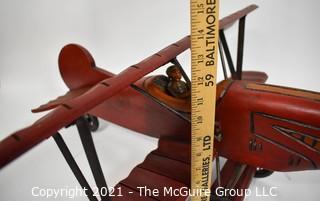 Vintage Red Painted Folk Art Hanging Wooden Biplane with Pilot.  Measures 26"L x  14"T  x 27"W. (TMG Business card placed for size perspective)