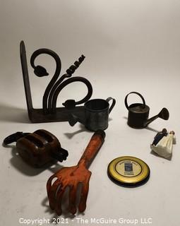 Group of Metal and Outdoor Items Including Cast Iron Bracket, Two (2) Miniature Watering Cans, Orange Garden Trowel, Vintage Anvil Brand Two-Strand Pully, Cake Topper Bride & Groom and Morton Salt Hand Mirror.