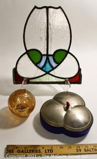 Group of Glass Items Including Stained Glass, Blue Glass Divided Candy Dish with Chrome Cover and Pink Iridescent Globe Piggy Bank.