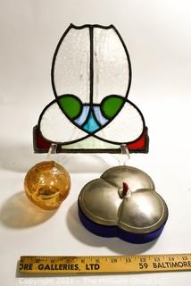 Group of Glass Items Including Stained Glass, Blue Glass Divided Candy Dish with Chrome Cover and Pink Iridescent Globe Piggy Bank.