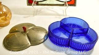 Group of Glass Items Including Stained Glass, Blue Glass Divided Candy Dish with Chrome Cover and Pink Iridescent Globe Piggy Bank.