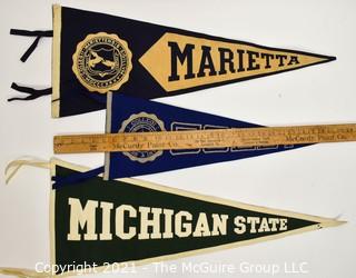 Three (3) Vintage Felt College Pennants - Marietta, Colby & Michigan State University.  Measures 29"L.