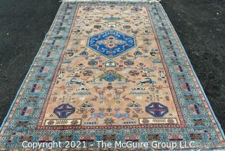 Vintage Hand Knotted Rug with Center Medallion and Border Pattern with Animals on Blue Background.  Measures 107 x 64", with some damage as shown. 