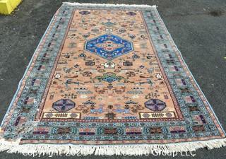 Vintage Hand Knotted Rug with Center Medallion and Border Pattern with Animals on Blue Background.  Measures 107 x 64", with some damage as shown. 