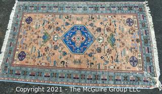 Vintage Hand Knotted Rug with Center Medallion and Border Pattern with Animals on Blue Background.  Measures 107 x 64", with some damage as shown. 