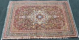 Vintage Hand Knotted Wool Rug with Center Medallion and Border Pattern on Blue Background.  Measures 105" x 71"  