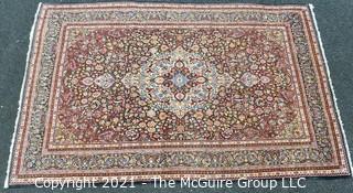 Vintage Hand Knotted Wool Rug with Center Medallion and Border Pattern on Blue Background.  Measures 105" x 71"  