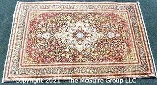 Vintage Hand Knotted Wool Rug with Center Medallion and Border Pattern on Blue Background.  Measures 105" x 71"  