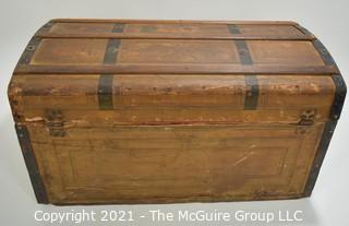 Primitive Antique Wood Camel Back Trunk with Metal Strapping and Red Interior.  Hand Painted Paper Decoration on Sides.  Measures 23"L x 13"T x 13"W.