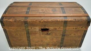 Primitive Antique Wood Camel Back Trunk with Metal Strapping and Red Interior.  Hand Painted Paper Decoration on Sides.  Measures 23"L x 13"T x 13"W.