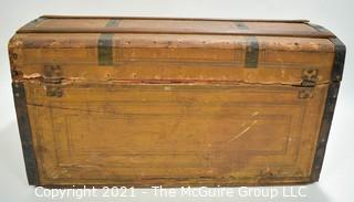 Primitive Antique Wood Camel Back Trunk with Metal Strapping and Red Interior.  Hand Painted Paper Decoration on Sides.  Measures 23"L x 13"T x 13"W.