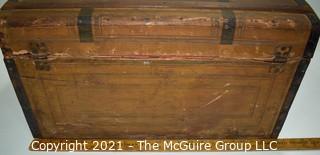 Primitive Antique Wood Camel Back Trunk with Metal Strapping and Red Interior.  Hand Painted Paper Decoration on Sides.  Measures 23"L x 13"T x 13"W.