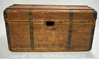 Primitive Antique Wood Camel Back Trunk with Metal Strapping and Red Interior.  Hand Painted Paper Decoration on Sides.  Measures 23"L x 13"T x 13"W.