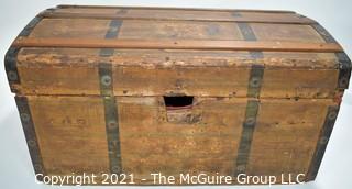 Primitive Antique Wood Camel Back Trunk with Metal Strapping and Red Interior.  Hand Painted Paper Decoration on Sides.  Measures 23"L x 13"T x 13"W.