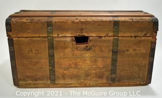 Primitive Antique Wood Camel Back Trunk with Metal Strapping and Red Interior.  Hand Painted Paper Decoration on Sides.  Measures 23"L x 13"T x 13"W.