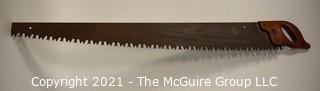 Vintage One Man "Warranted Superior" Crosscut Logging Saw. Measures 49" long.