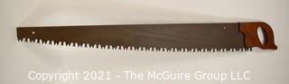 Vintage One Man "Warranted Superior" Crosscut Logging Saw. Measures 49" long.