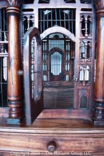 Antique Victorian Monumental Mahogany Continental Carved Sacre Coeur "Cathedral" Bird Cage with Table Base. Modeled with removable central dome, towers at each corner, portico  and hinged doors on each side, refuse drawer, on conforming carved stand.  Measures 70" tall and 26" square. 