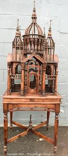 Antique Victorian Monumental Mahogany Continental Carved Sacre Coeur "Cathedral" Bird Cage with Table Base. Modeled with removable central dome, towers at each corner, portico  and hinged doors on each side, refuse drawer, on conforming carved stand.  Measures 70" tall and 26" square. 