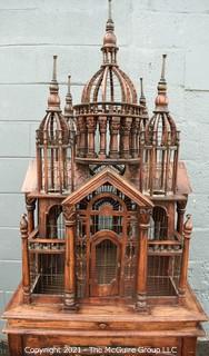 Antique Victorian Monumental Mahogany Continental Carved Sacre Coeur "Cathedral" Bird Cage with Table Base. Modeled with removable central dome, towers at each corner, portico  and hinged doors on each side, refuse drawer, on conforming carved stand.  Measures 70" tall and 26" square. 