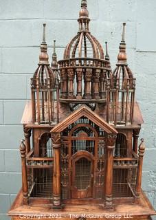 Antique Victorian Monumental Mahogany Continental Carved Sacre Coeur "Cathedral" Bird Cage with Table Base. Modeled with removable central dome, towers at each corner, portico  and hinged doors on each side, refuse drawer, on conforming carved stand.  Measures 70" tall and 26" square. 