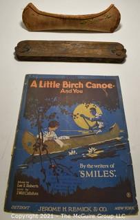 Sheet Music and Miniature Birch Bark Canoe