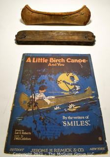 Sheet Music and Miniature Birch Bark Canoe