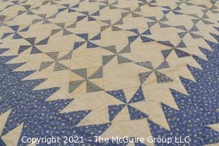 Vintage Hand Made Quilt Signed by Isabella Young in the Pinwheel Pattern in Blue & White.  Some Wear due to age. Measures 72" x 75".