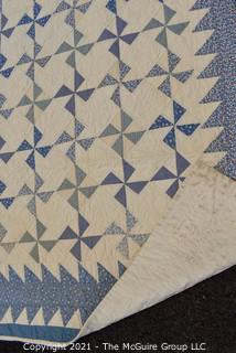 Vintage Hand Made Quilt Signed by Isabella Young in the Pinwheel Pattern in Blue & White.  Some Wear due to age. Measures 72" x 75".