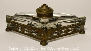 French Revival Crystal Inkwell in Brass Stand with Cherubs. Measures 9" Long.