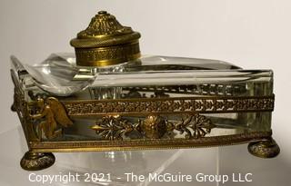 French Revival Crystal Inkwell in Brass Stand with Cherubs. Measures 9" Long.