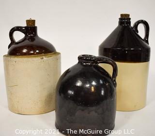 Collection Of Three (3) Primitive Antique Stoneware Utilitarian Crocks or Jugs with Brown Albany Slip Tops. Two Jugs Have Original Corked Tops. 