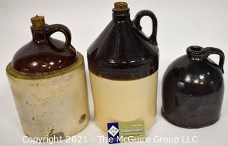 Collection Of Three (3) Primitive Antique Stoneware Utilitarian Crocks or Jugs with Brown Albany Slip Tops. Two Jugs Have Original Corked Tops. 