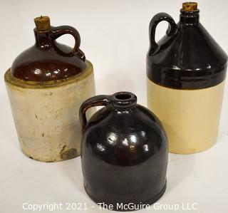 Collection Of Three (3) Primitive Antique Stoneware Utilitarian Crocks or Jugs with Brown Albany Slip Tops. Two Jugs Have Original Corked Tops. 