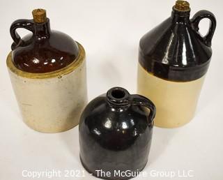 Collection Of Three (3) Primitive Antique Stoneware Utilitarian Crocks or Jugs with Brown Albany Slip Tops. Two Jugs Have Original Corked Tops. 