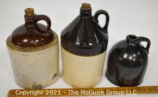 Collection Of Three (3) Primitive Antique Stoneware Utilitarian Crocks or Jugs with Brown Albany Slip Tops. Two Jugs Have Original Corked Tops. 