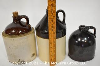 Collection Of Three (3) Primitive Antique Stoneware Utilitarian Crocks or Jugs with Brown Albany Slip Tops. Two Jugs Have Original Corked Tops. 