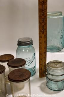 Selection of Vintage Blown Glass Canning Supplies and Baby Brand Condensed Milk Jars with Lids.