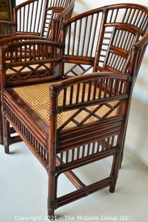 Two (2) Asian Style Rattan Arm Chairs with Cane Seats.  Measure 34" x 22" x 20".