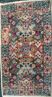 Hand Woven Persian Rug on White Ground. Measures approximately 26" x 49".