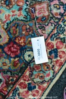 Hand Woven Persian Rug on White Ground. Measures approximately 26" x 49".