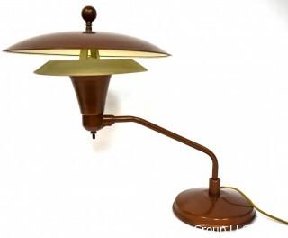 Mid Century Swiveling Table Lamp with Tiered Metal Saucer Shade. Measures 17" tall.