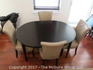 Wooden Dining Table and set of 4 upholstered side chairs; 33" circle without leaf; with leaf - 42" diameter long side  