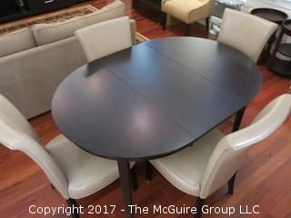 Wooden Dining Table and set of 4 upholstered side chairs; 33" circle without leaf; with leaf - 42" diameter long side  